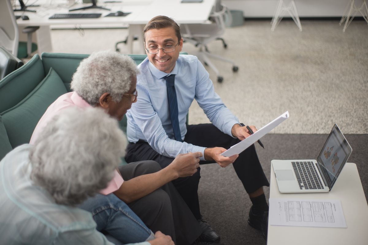 An older Utah parent and an adult family member reviewing estate planning paperwork together at home.